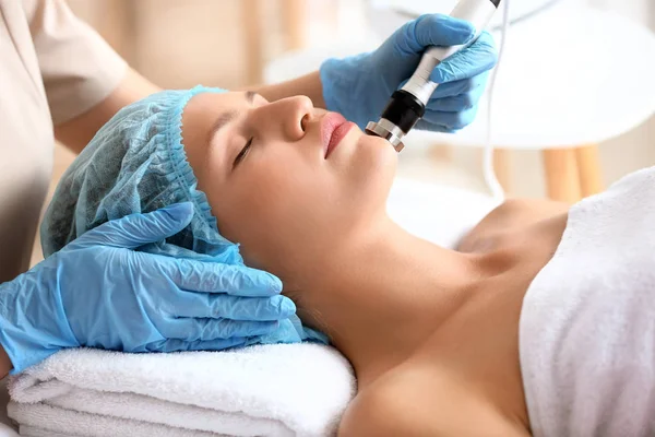Young woman undergoing procedure of rf lifting in beauty salon — Stock Photo, Image