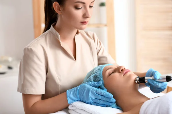 Young woman undergoing procedure of rf lifting in beauty salon — Stock Photo, Image