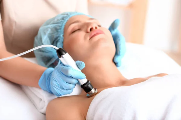 Young woman undergoing procedure of rf lifting in beauty salon — Stock Photo, Image