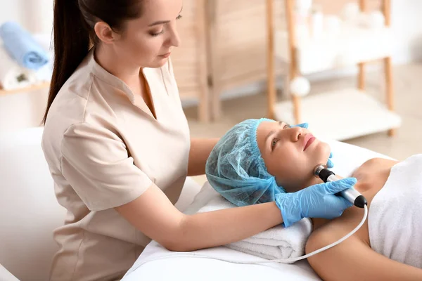 Young woman undergoing procedure of rf lifting in beauty salon — Stock Photo, Image