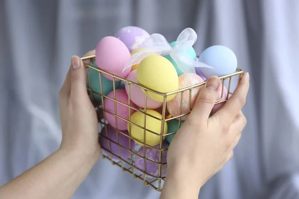 Woman holding basket with Easter eggs, closeup — Stock Photo, Image