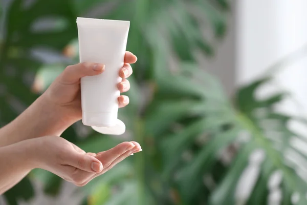 Hands of young woman applying cream at home — Stock Photo, Image