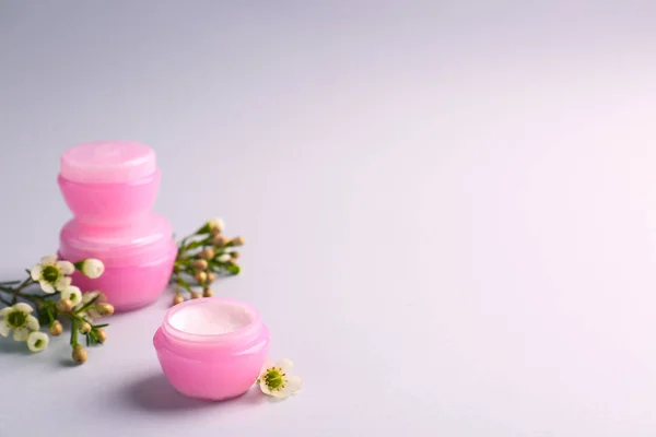 Jars of natural cream on light background — Stock Photo, Image