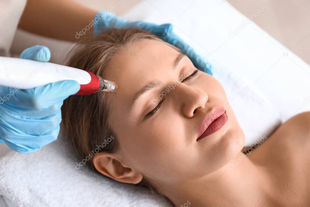 Young woman undergoing procedure of bb glow treatment in beauty salon