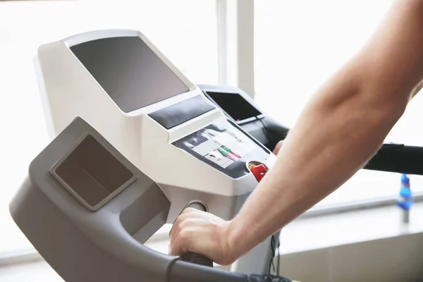 Sporty young man training on treadmill in gym — Stock Photo, Image