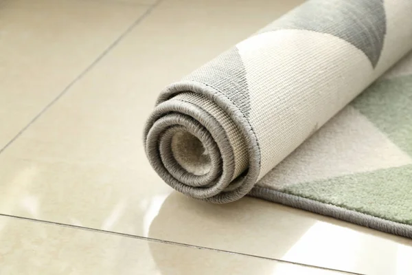 Rolled carpet on floor in room — Stock Photo, Image