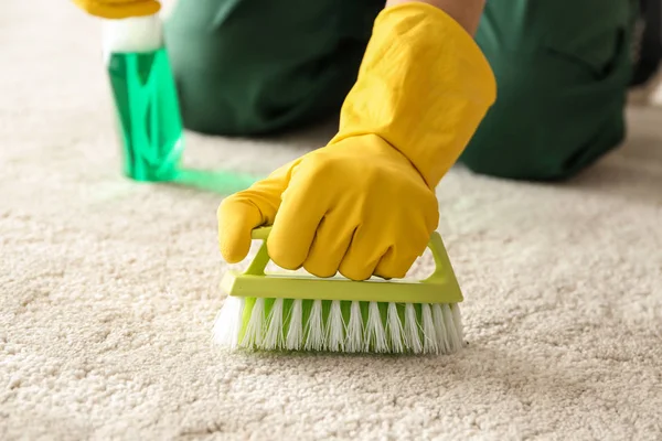 Worker cleaning carpet, closeup