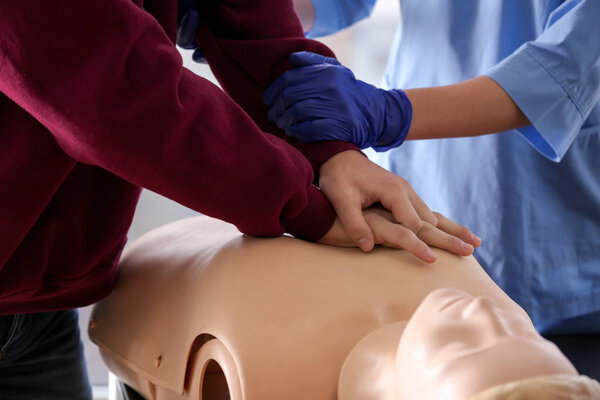 Man learning to perform CPR at first aid training course, closeup