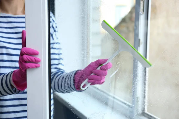 Woman washing window at home — Stock Photo, Image