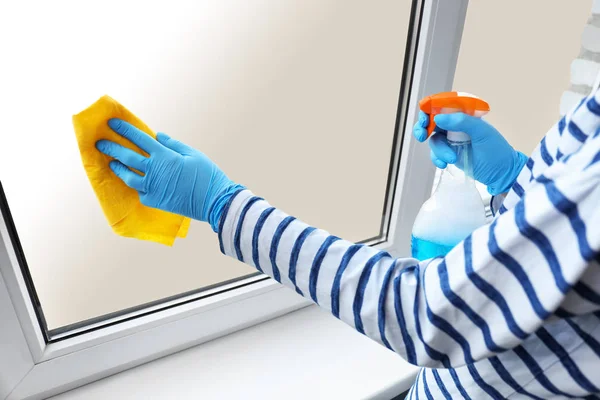 Kobieta mycie okien w domu — Zdjęcie stockowe