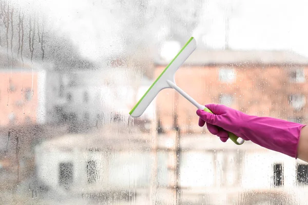 Mujer lavando ventana en casa — Foto de Stock