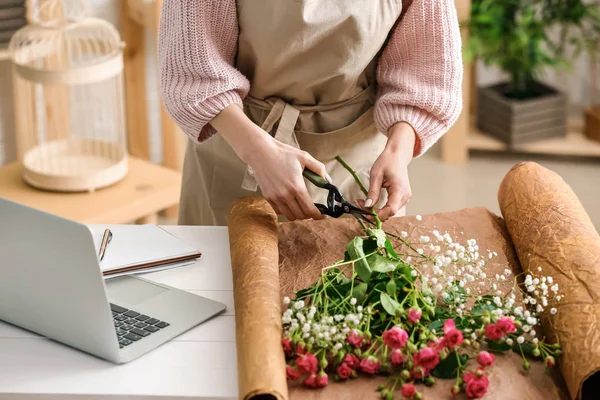 Beautiful female florist working at table in shop, closeup — Stock Photo, Image