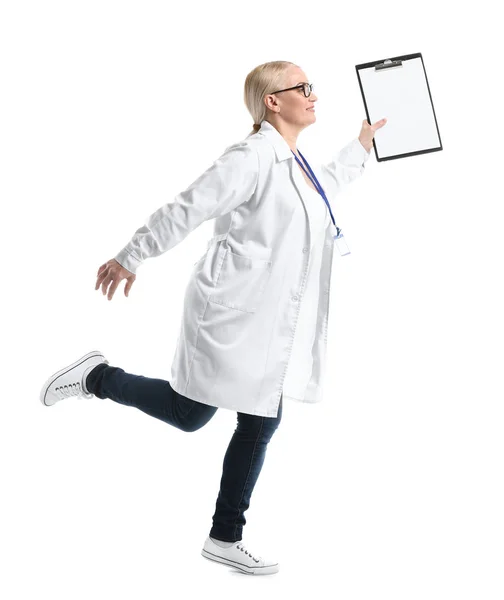 Mature female doctor running against white background