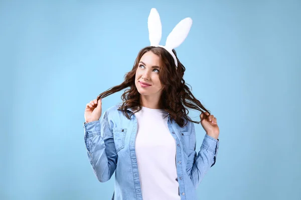 Beautiful young woman with bunny ears on color background — Stock Photo, Image