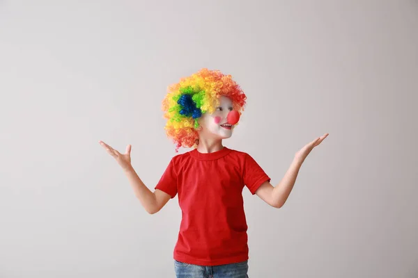 Little boy in funny disguise on light background. April fool's day celebration — Stock Photo, Image