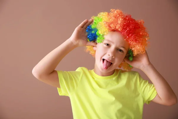 Little boy in funny disguise on color background. April fools' day celebration — Stock Photo, Image