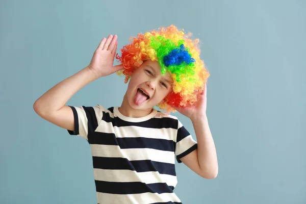 Kleine jongen in grappige vermomming op kleur achtergrond. April Fools ' dag viering — Stockfoto