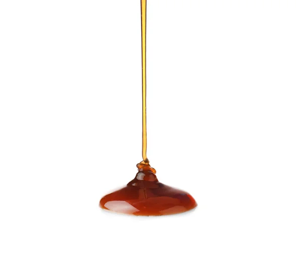 Pouring liquid caramel on white background — Stock Photo, Image