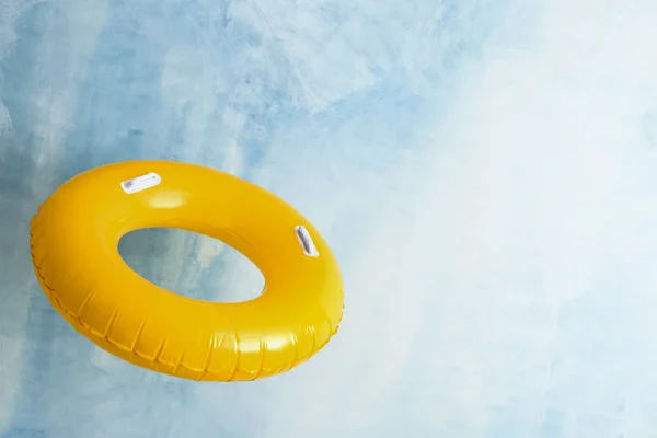 Bright inflatable ring on color background — Stock Photo, Image