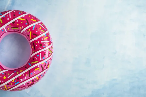 Bright inflatable ring on color background — Stock Photo, Image