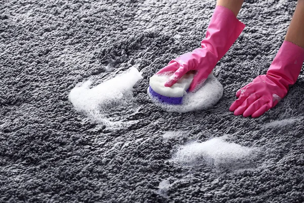Kvinna rengöring mattan hemma — Stockfoto