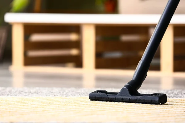 Brush of vacuum cleaner on carpet in room — Stock Photo, Image
