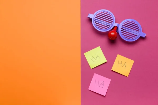 Funny eyeglasses with sticky notes on color background. April Fool's Day celebration — Stock Photo, Image