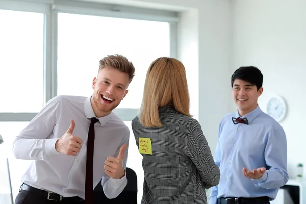 Young man playing a prank on his colleague in office. April Fools' Day prank — Stock Photo, Image