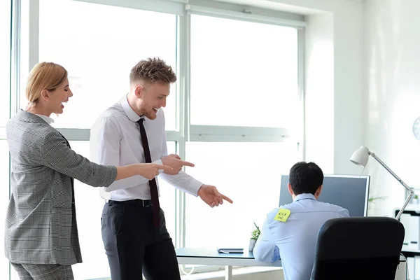 Friends playing a prank on their colleague in office. April Fools' Day prank — Stock Photo, Image