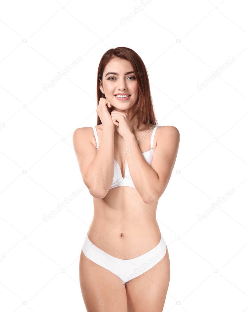 Beautiful young woman in underwear on white background