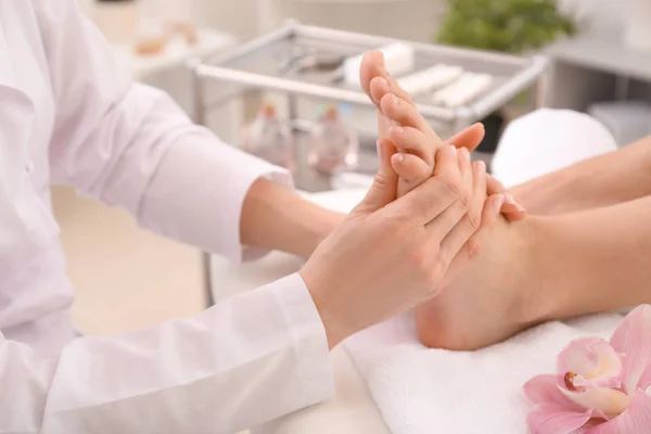 Young woman receiving feet massage in spa salon — Stock Photo, Image