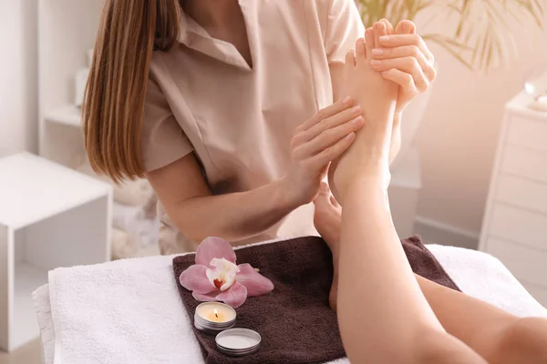 Mujer joven recibiendo masaje de pies en el salón de spa — Foto de Stock