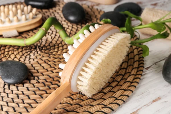 Massage brush with spa stones on white table — Stock Photo, Image