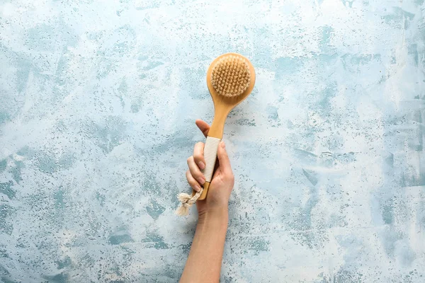 Female hand with massage brush on color background — Stock Photo, Image