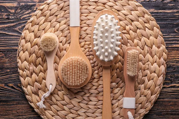 Different massage brushes on wooden table — Stock Photo, Image