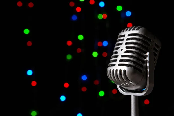 Retro microphone against defocused lights — Stock Photo, Image