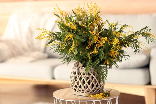 Vase with bouquet of mimosa flowers on table in room — Stock Photo, Image