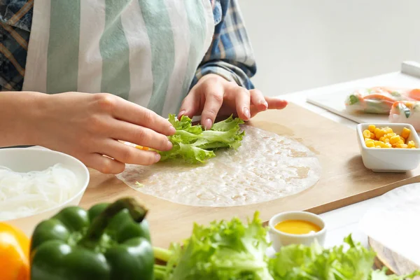 Kvinna som förbereder läckra vårrullar — Stockfoto