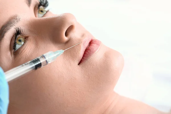 Young woman receiving filler injection in beauty salon, closeup — Stock Photo, Image