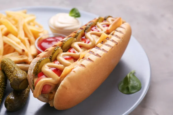 Tasty hot dog on plate, closeup — Stock Photo, Image