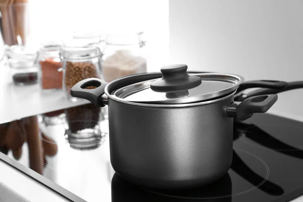 Saucepan on electric stove in kitchen — Stock Photo, Image