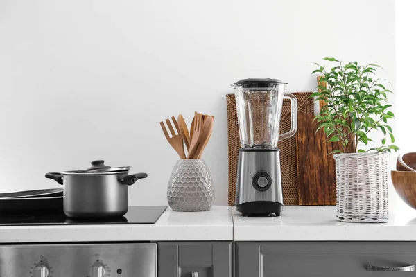 Set of utensils and blender in kitchen — Stock Photo, Image