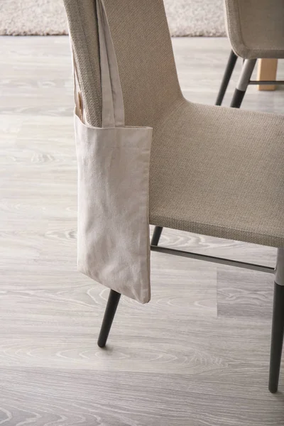 Eco bag hanging on back of chair in room — Stock Photo, Image