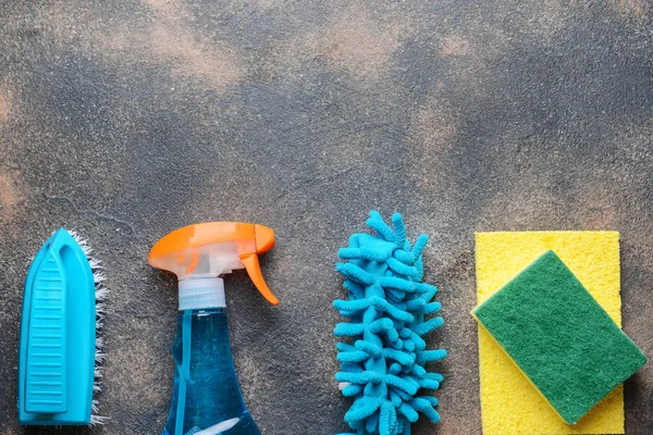 Set of cleaning supplies on grunge background — Stock Photo, Image