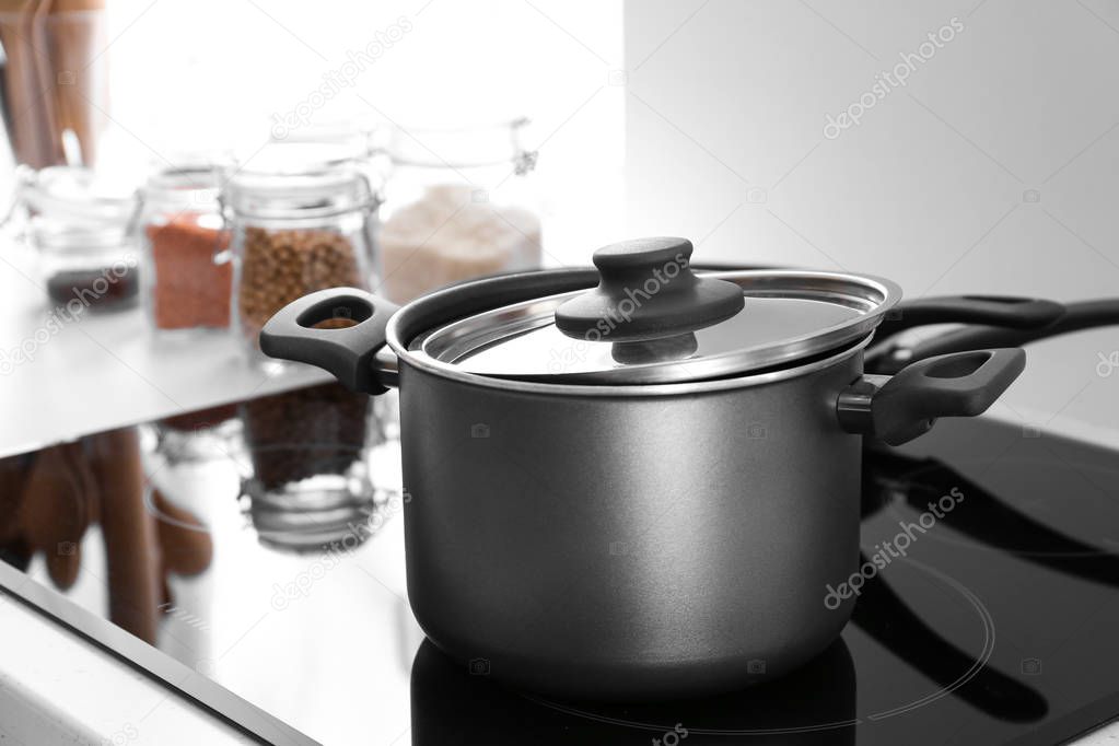 Saucepan on electric stove in kitchen