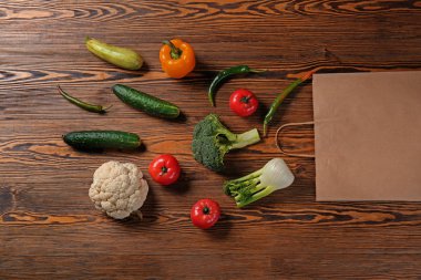 Ahşap arka plan üzerinde taze sebze ile eko kese kağıdı