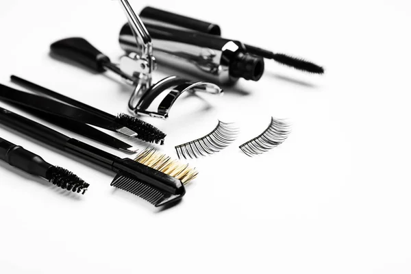 Mascara with false eyelashes and tools on white background — Stock Photo, Image