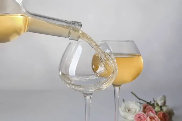 Pouring of wine into glass on light background — Stock Photo, Image