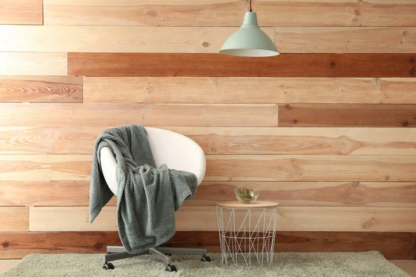 Chair and table near wooden wall — Stock Photo, Image