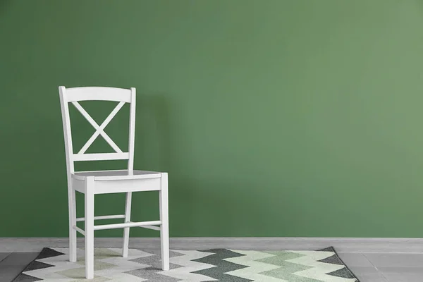 Chair near color wall in room — Stock Photo, Image